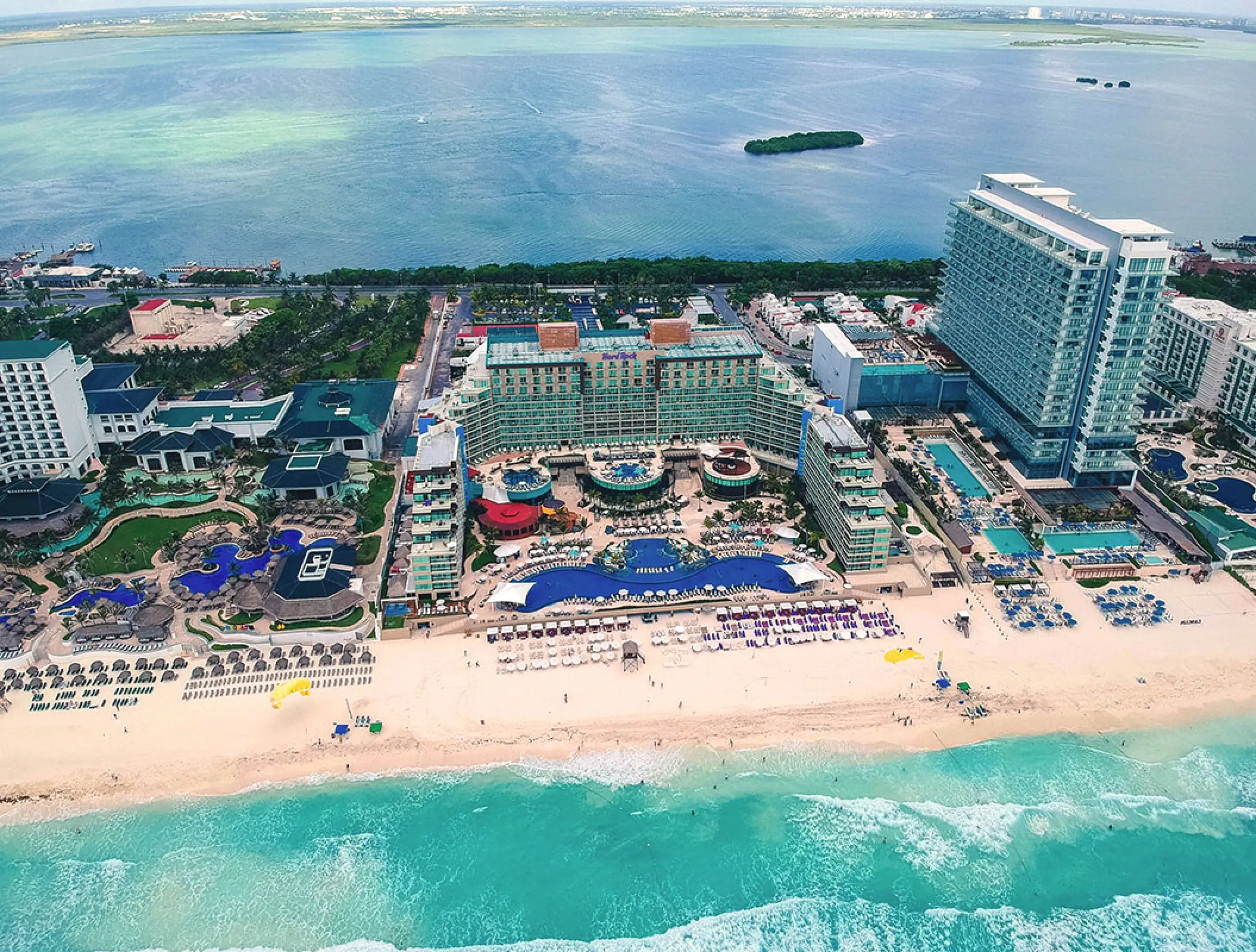 Aerial view of Hard Rock Cancun pools and white sand beach between the Caribbean Sea and Nichupté Lagoon
