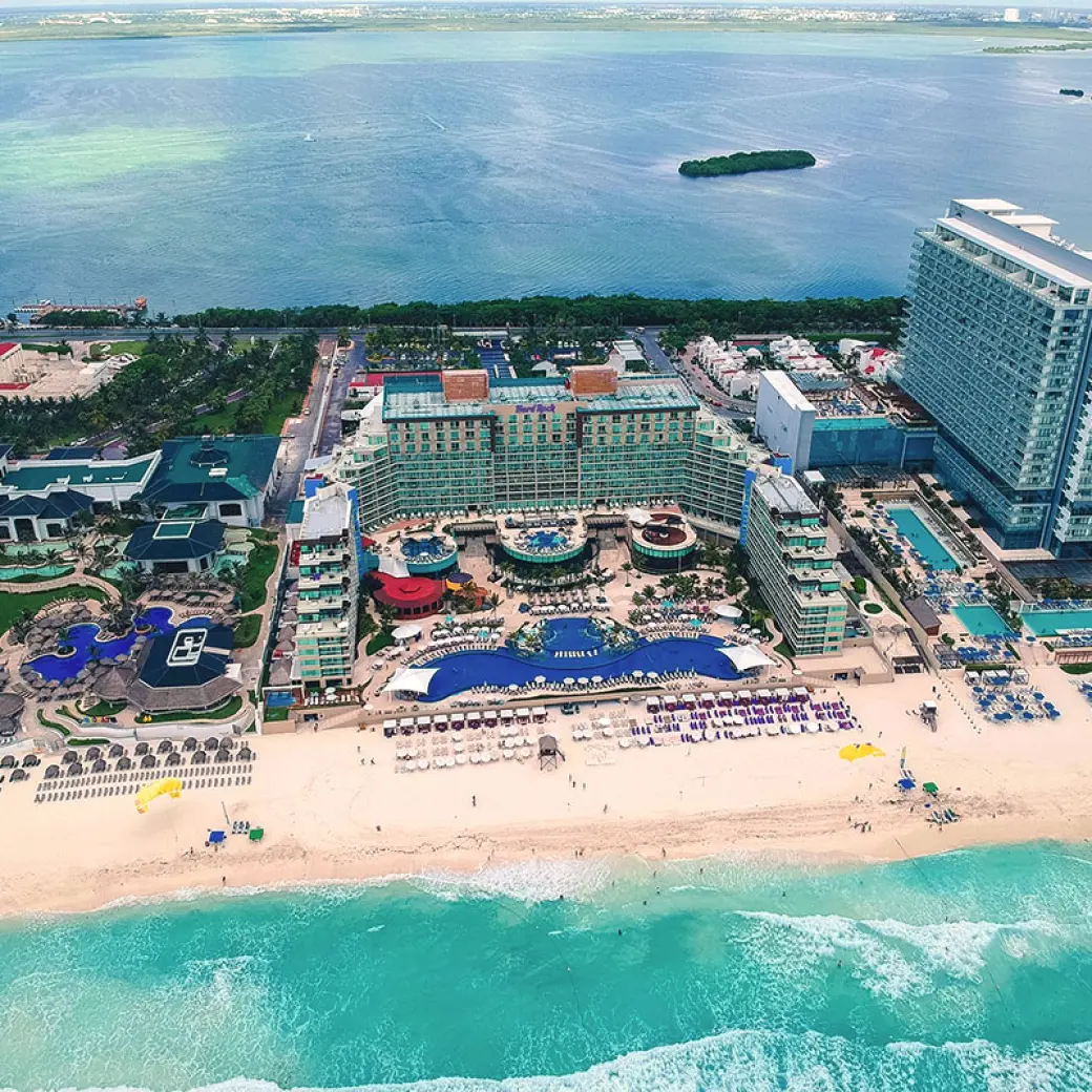 Aerial view of Hard Rock Cancun pools and white sand beach between the Caribbean Sea and Nichupté Lagoon
