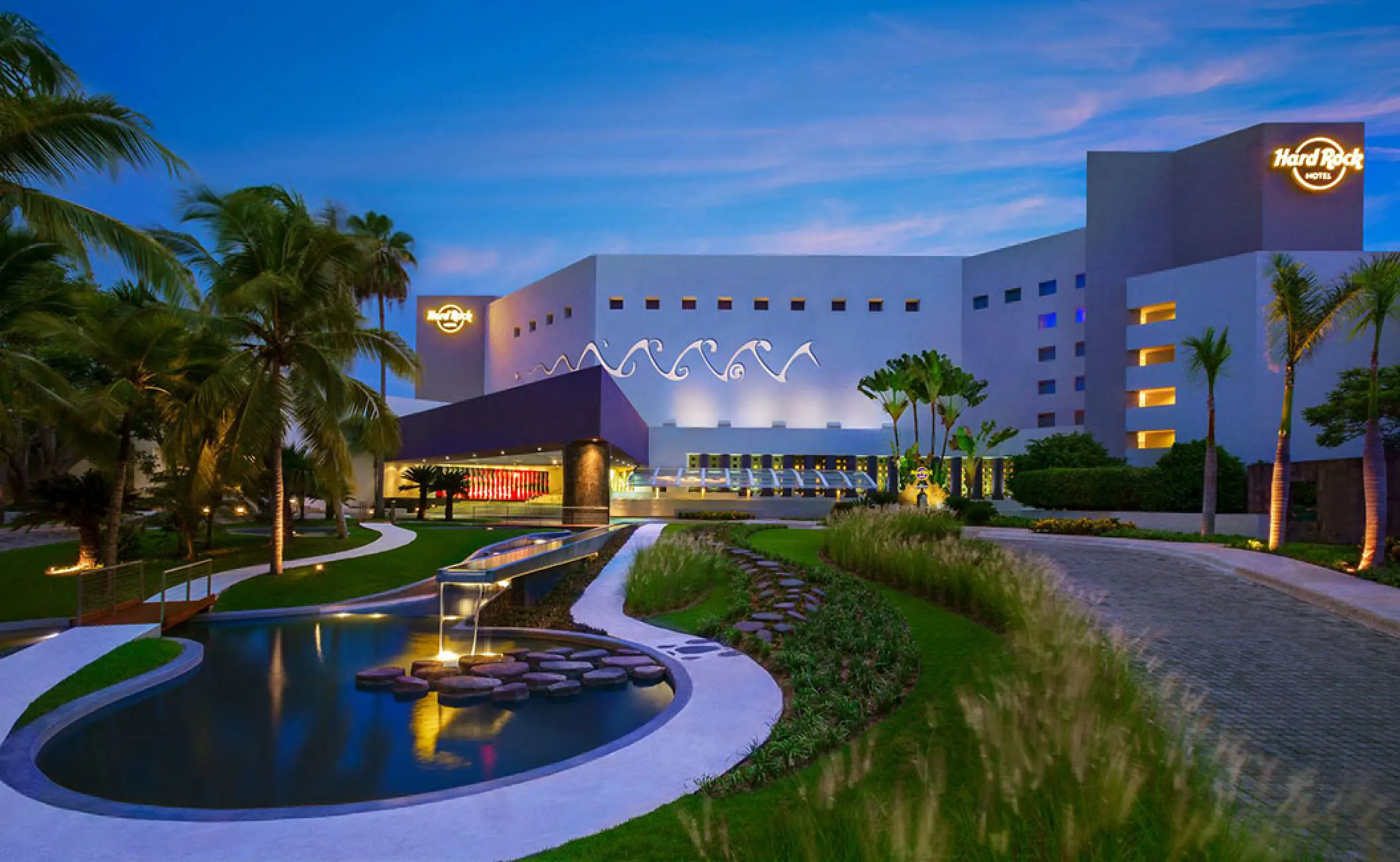 Hard Rock Vallarta motor lobby and landscaped entrance with ponds at dusk, Puerto Vallarta