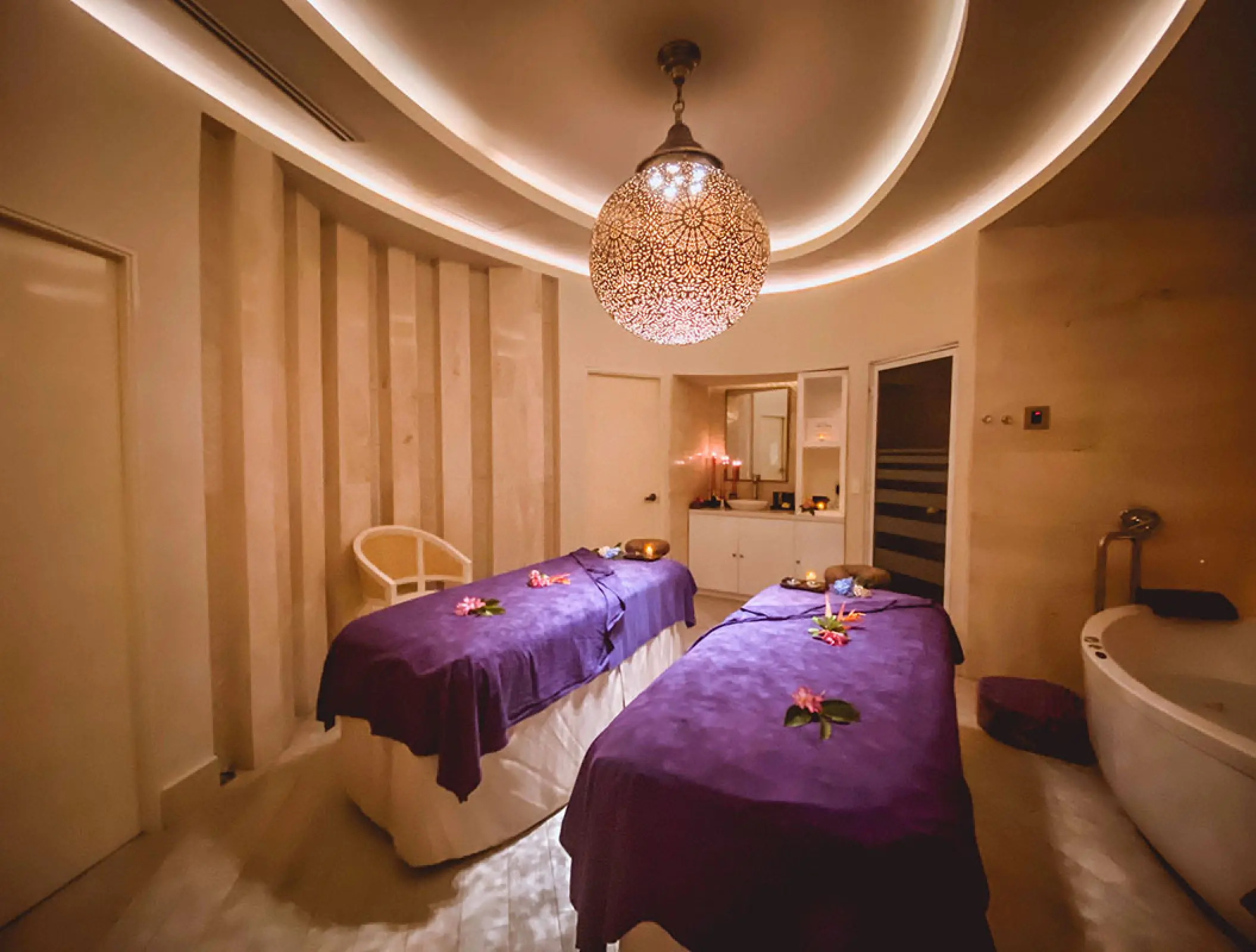 Spa treatment room with two massage tables and a soaking tub at Hard Rock Vallarta, Puerto Vallarta