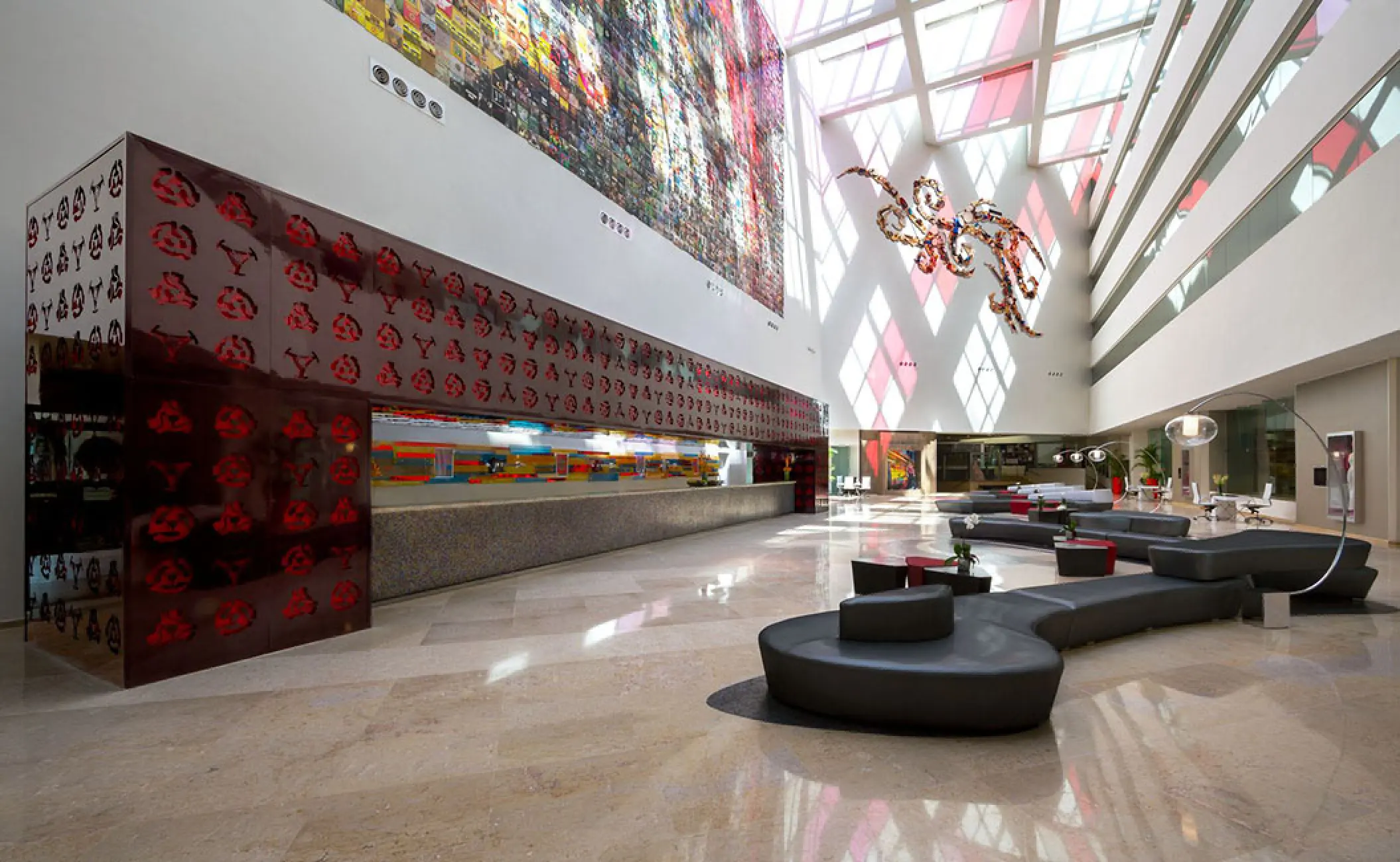 Modern atrium lobby with red accents and geometric seating at Hard Rock Vallarta, Puerto Vallarta