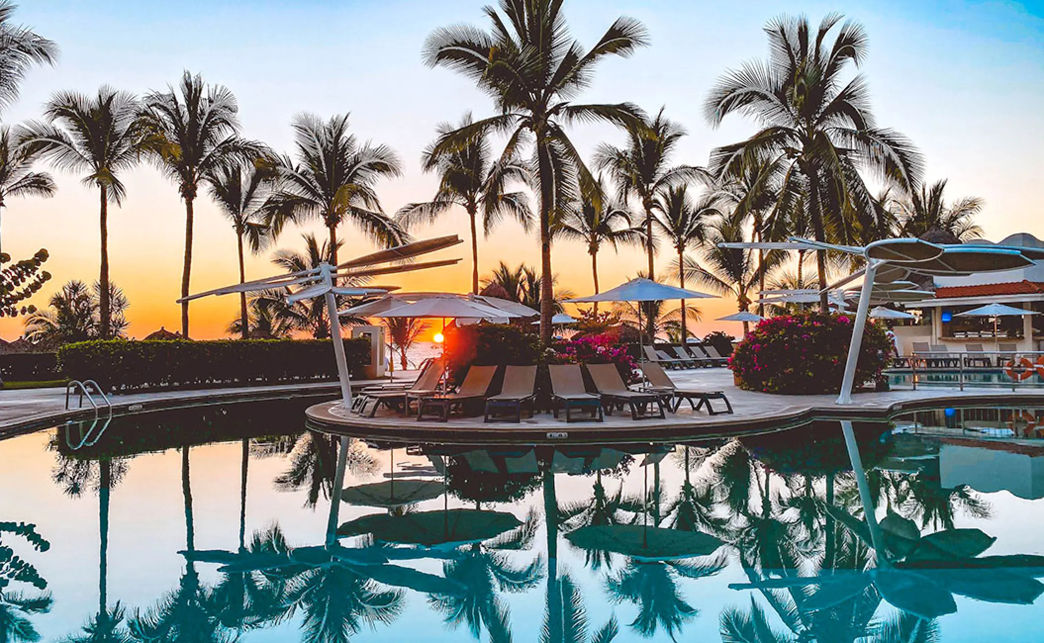 Palm trees reflecting in the swimming pool at sunset, Hard Rock Vallarta, Puerto Vallarta