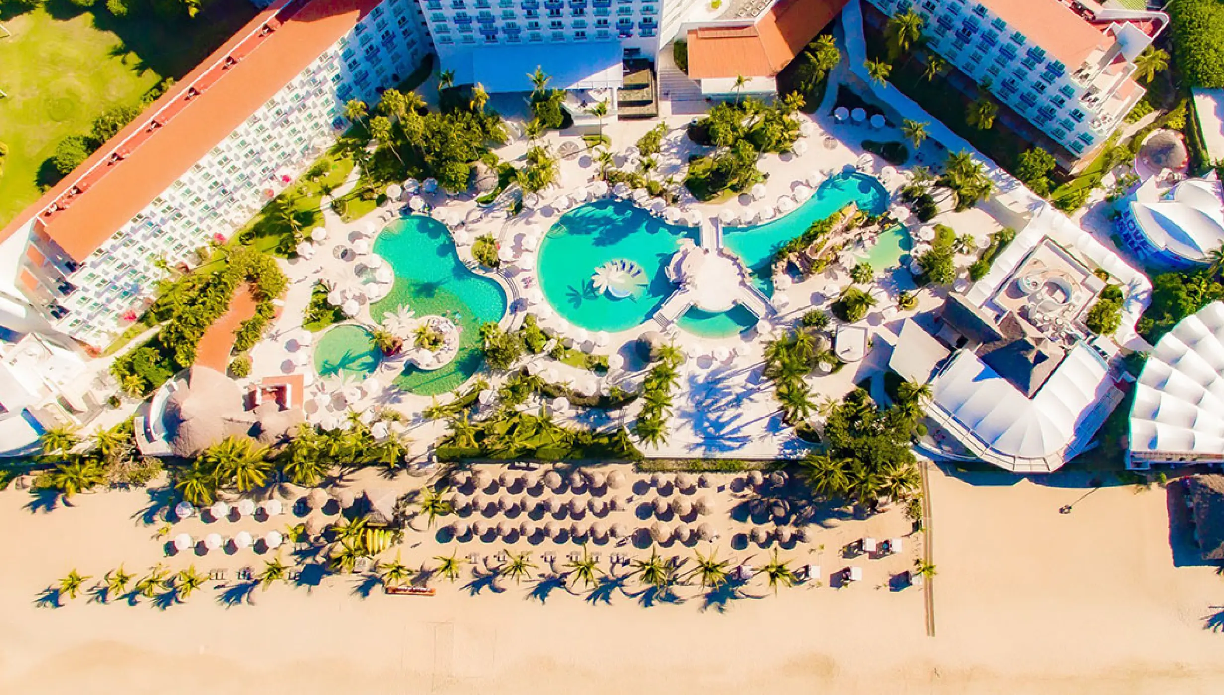 Aerial view of swimming pools and beach lounge area at Hard Rock Hotel Vallarta, Puerto Vallarta
