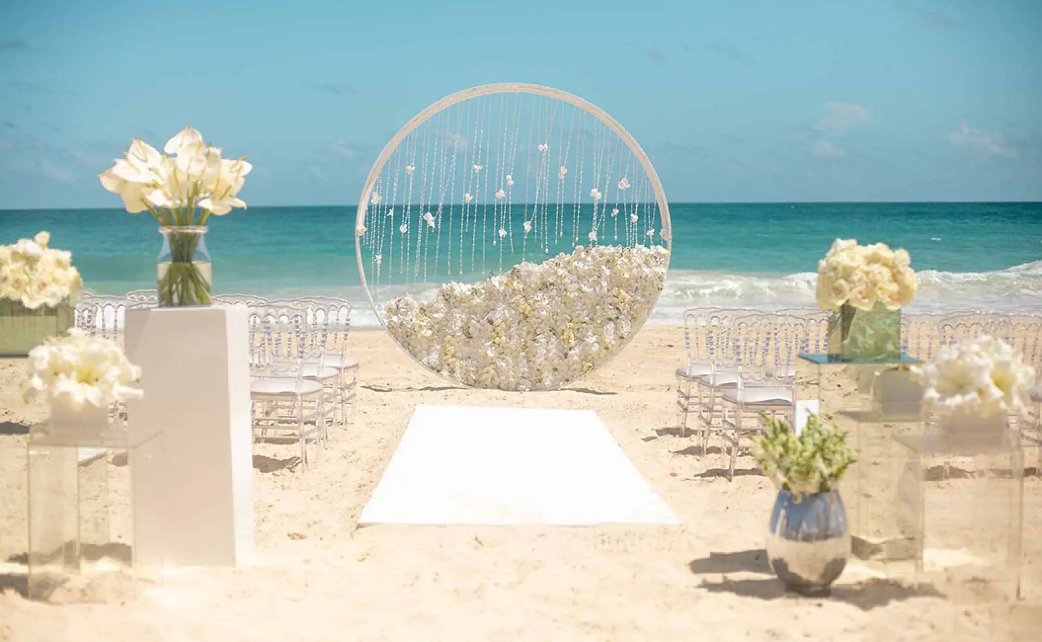 Circular floral arch for a beach ceremony at Hard Rock Vallarta, Puerto Vallarta