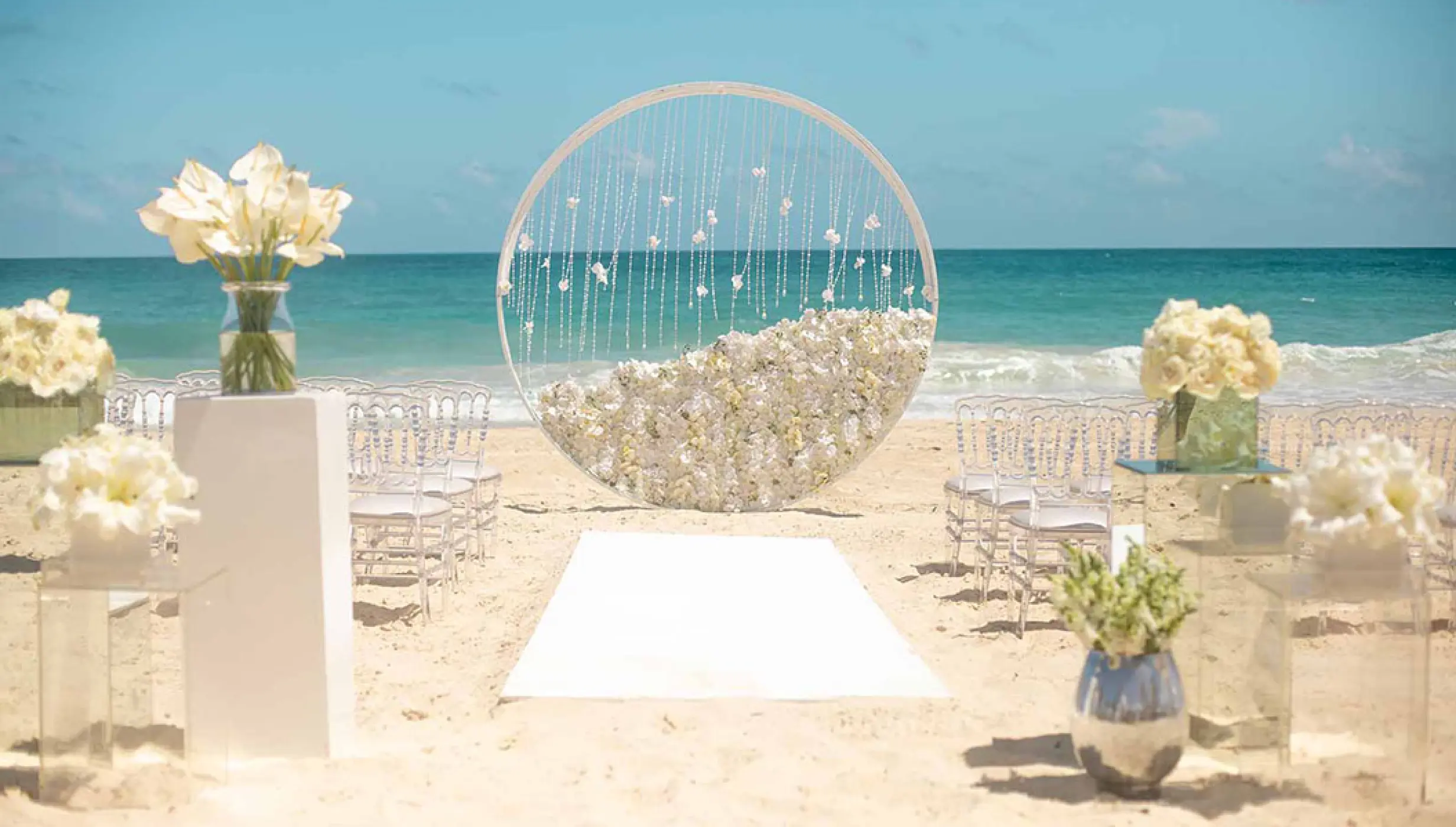 Circular floral arch for a beach ceremony at Hard Rock Vallarta, Puerto Vallarta