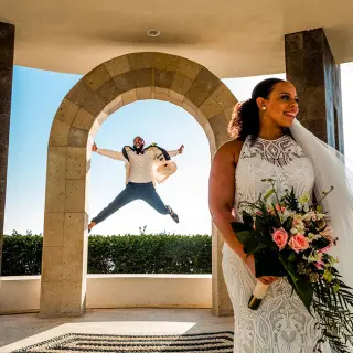 Groom jumping in the air behind a bride at Hard Rock Hotel Vallarta, Puerto Vallarta