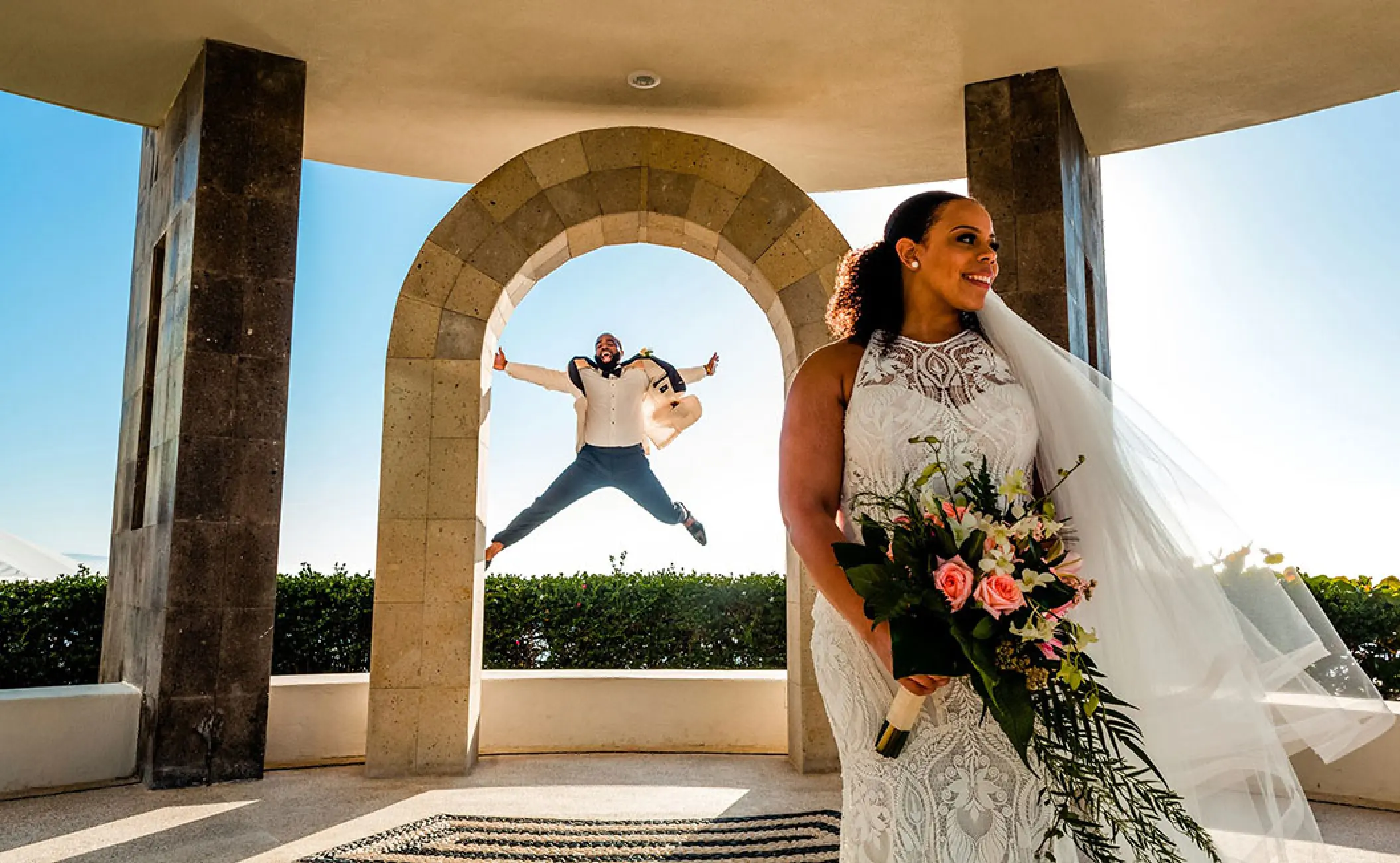 Groom jumping in the air behind a bride at Hard Rock Hotel Vallarta, Puerto Vallarta