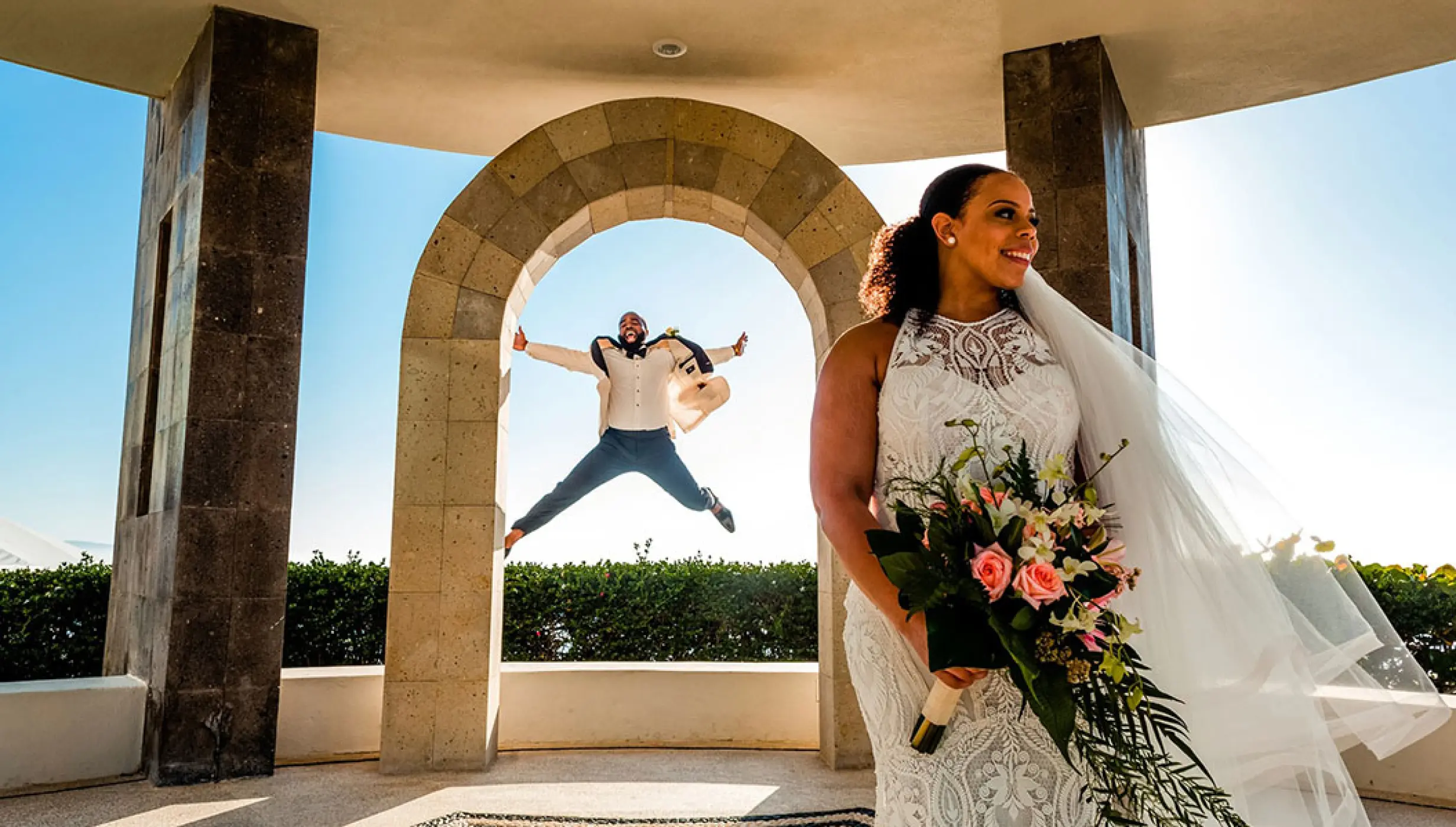 Groom jumping in the air behind a bride at Hard Rock Hotel Vallarta, Puerto Vallarta