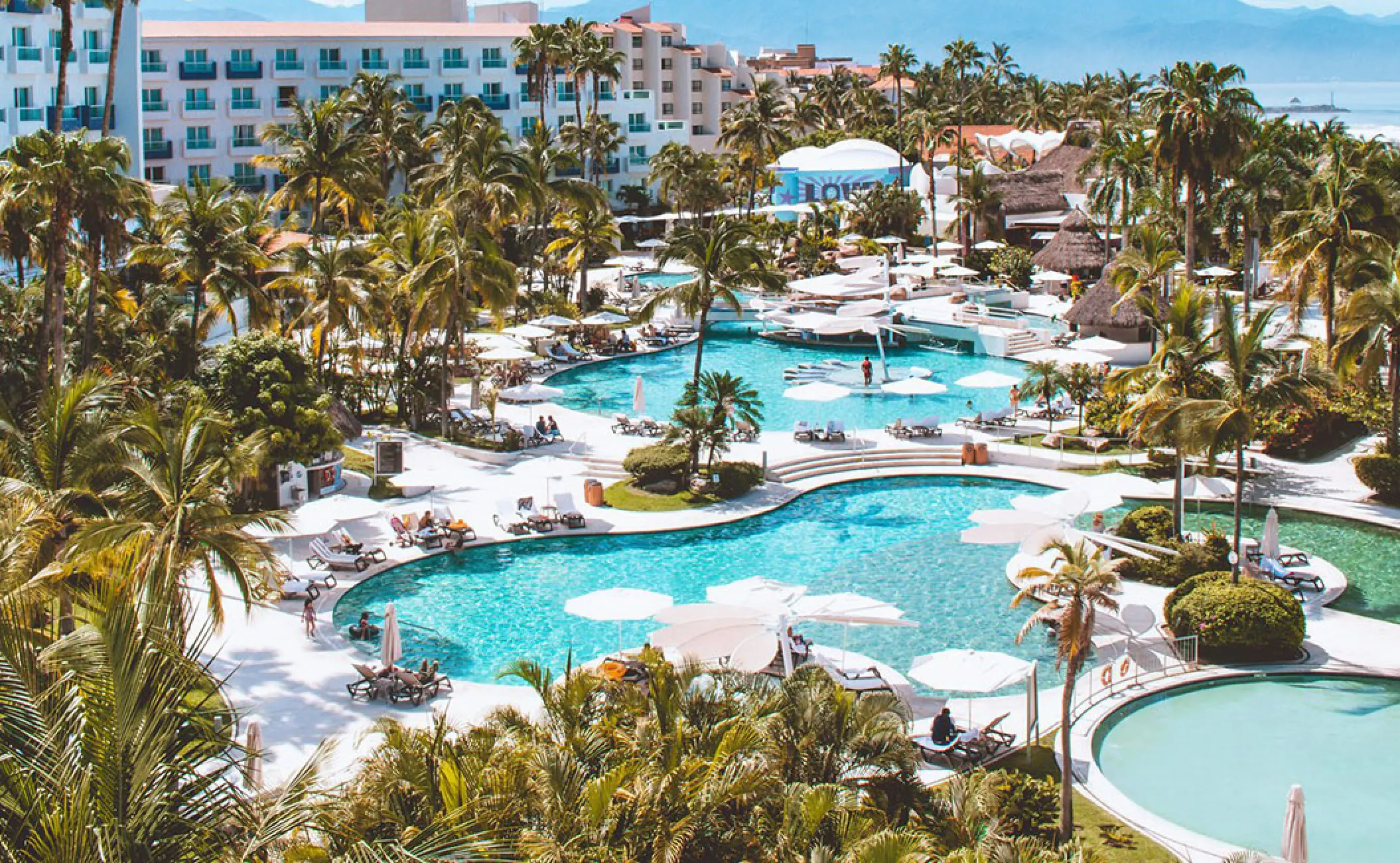 Aerial view of swimming pools and palm trees at Hard Rock Vallarta, Puerto Vallarta