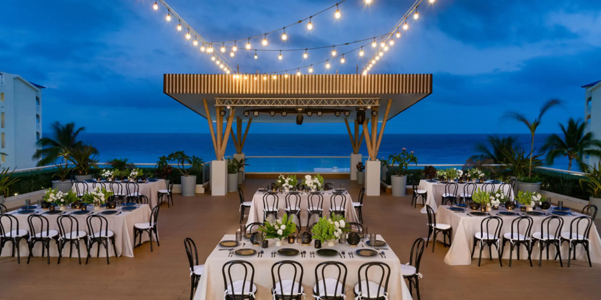 Chala Sky Venue wedding reception with string lights at Hilton Cancun Mar Caribe, Cancun