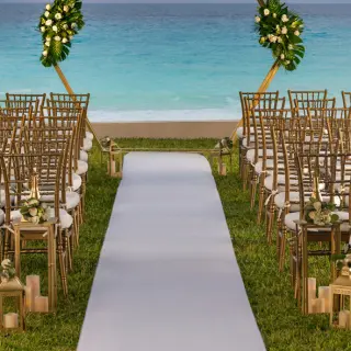 South Garden wedding ceremony with gold chairs and floral arch at Hilton Cancun Mar Caribe, Cancun