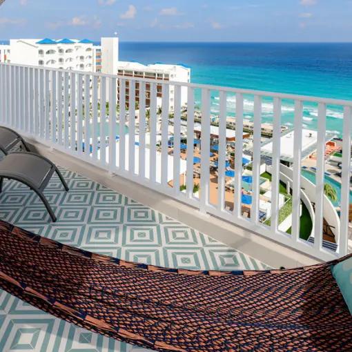 Private suite balcony with a hammock overlooking the Caribbean Sea at Hilton Cancun Mar Caribe