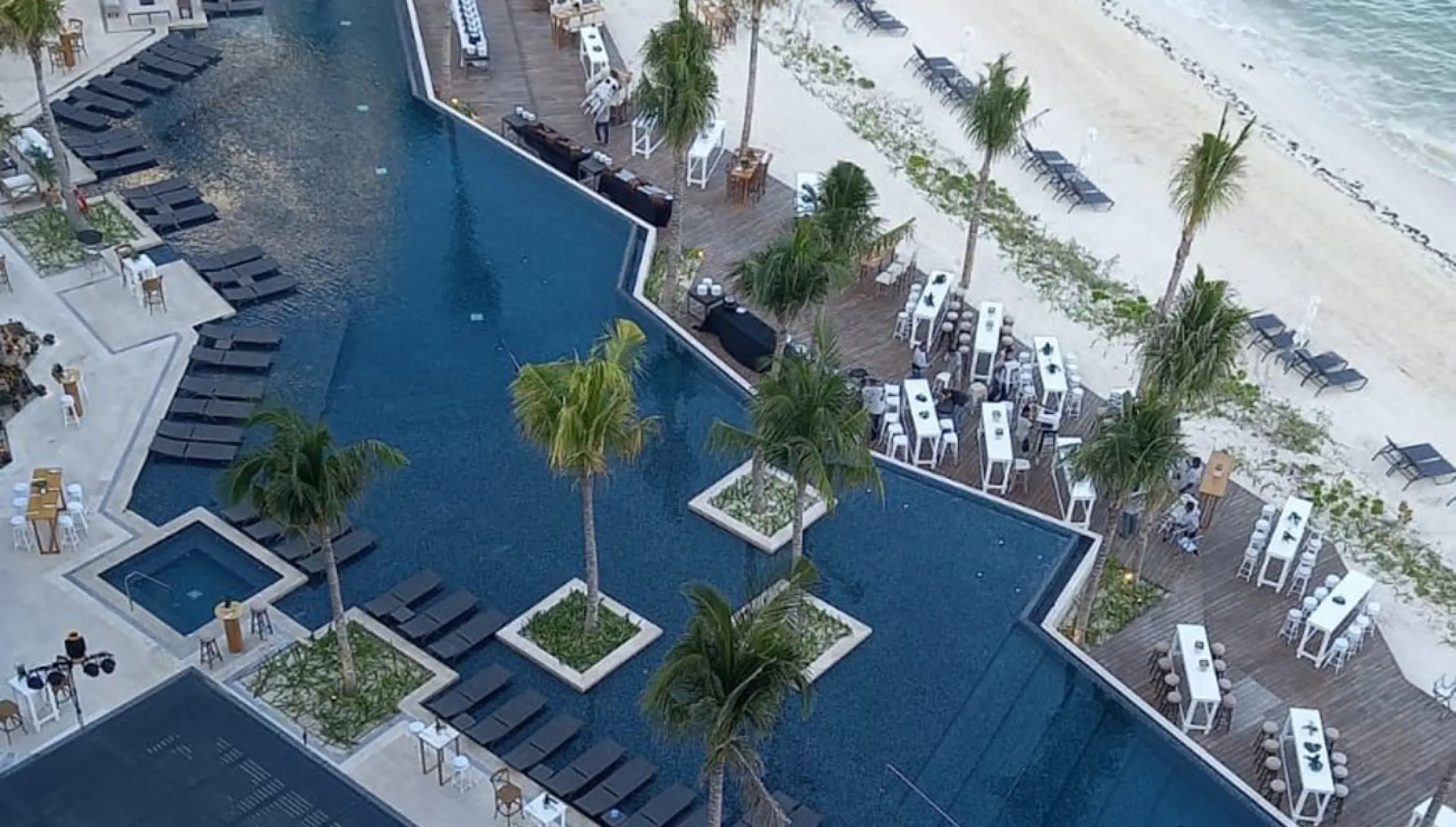 Aerial view of the South Pool wedding reception setup at Hilton Cancun, Cancun