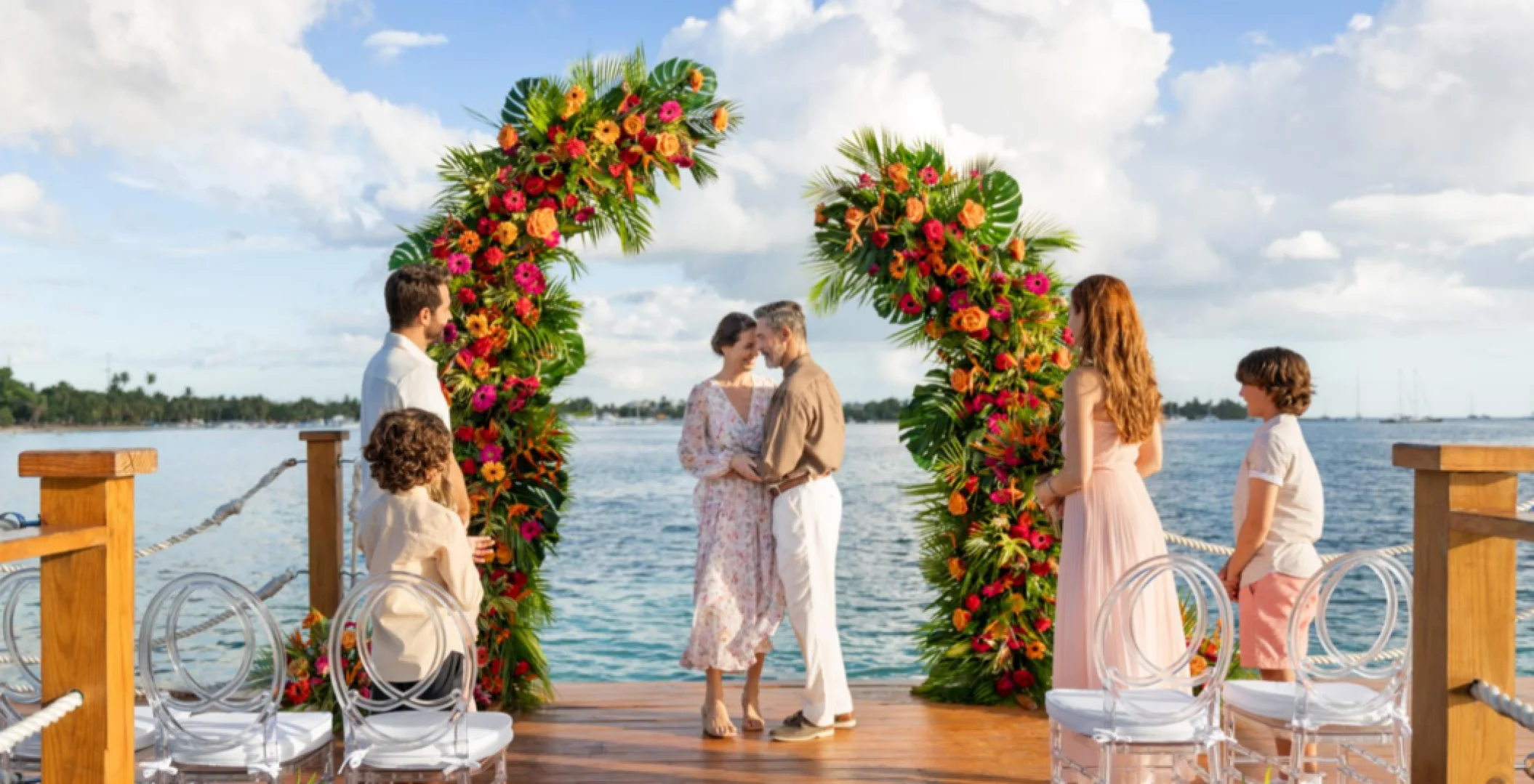bride, groom, and guests at the pier venue at Dreams La Romana Resort & Spa