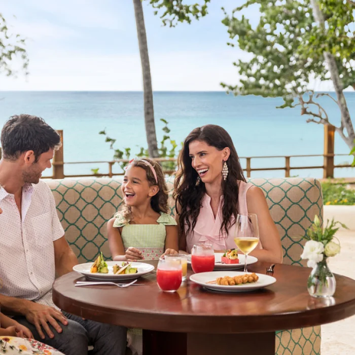 family at a restaurant at Dreams La Romana Resort & Spa