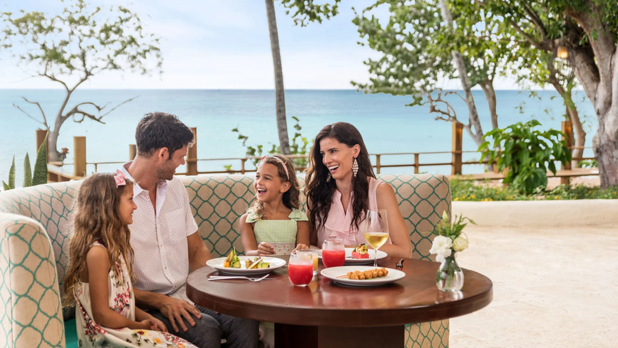 family at a restaurant at Dreams La Romana Resort & Spa