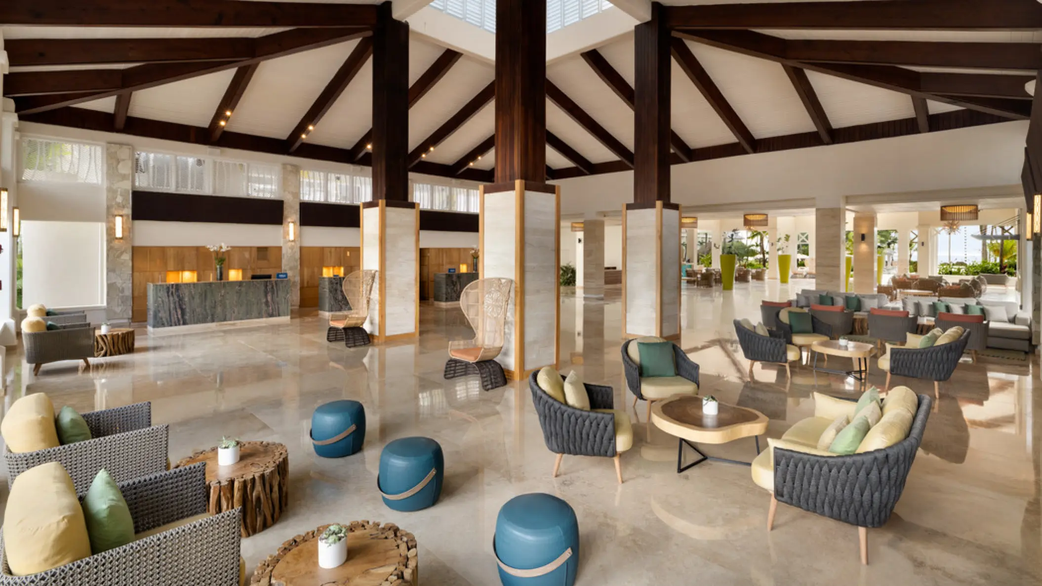 Open-air lobby with vaulted wooden ceilings and modern lounge seating at Hilton La Romana, La Romana