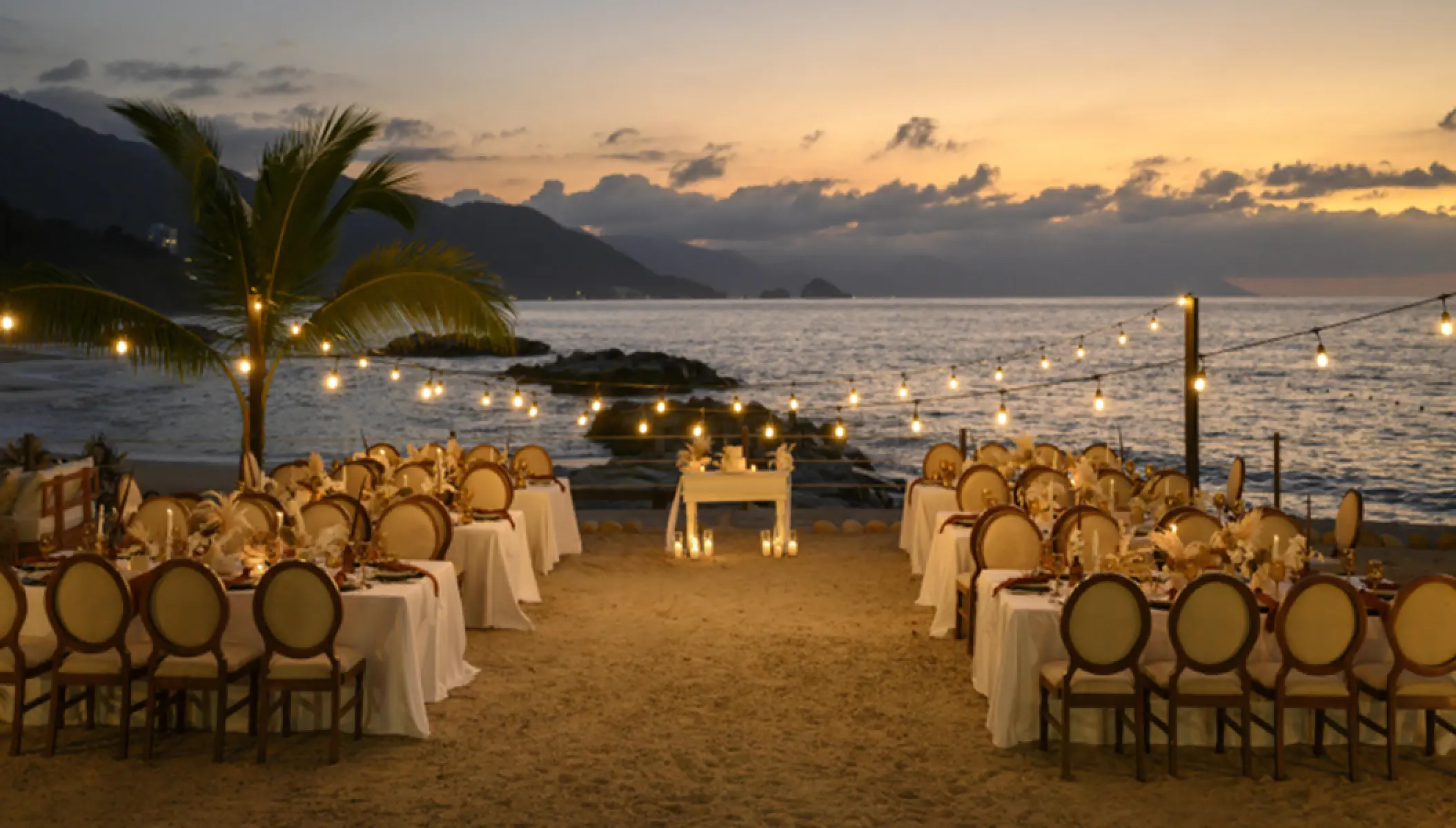 Beachfront wedding reception under string lights at Hilton Vallarta Riviera, Puerto Vallarta