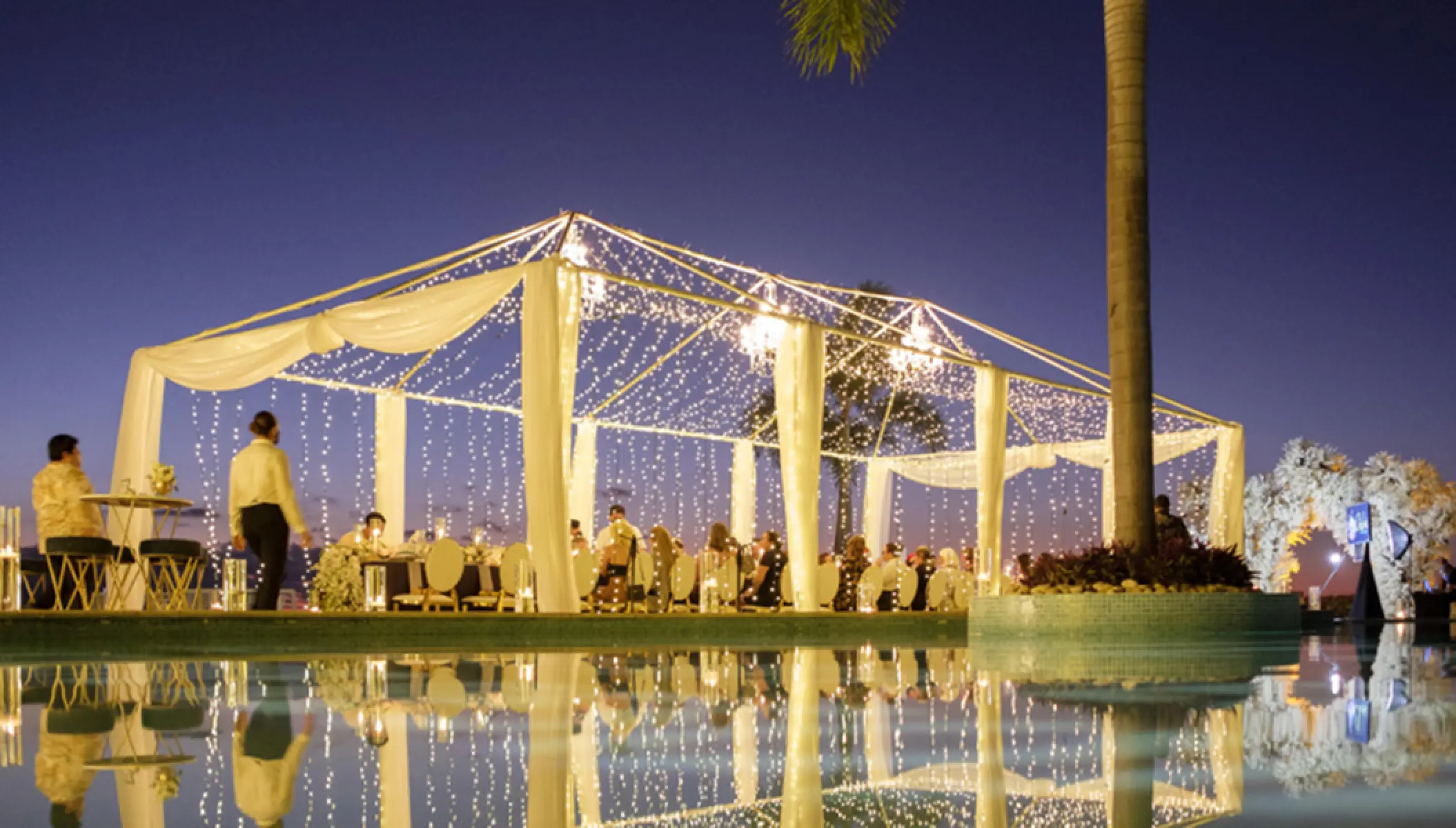 Evening wedding reception under a lighted canopy at Hilton Vallarta Riviera, Puerto Vallarta