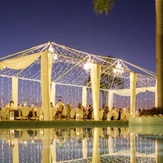 Evening wedding reception under a lighted canopy at Hilton Vallarta Riviera, Puerto Vallarta