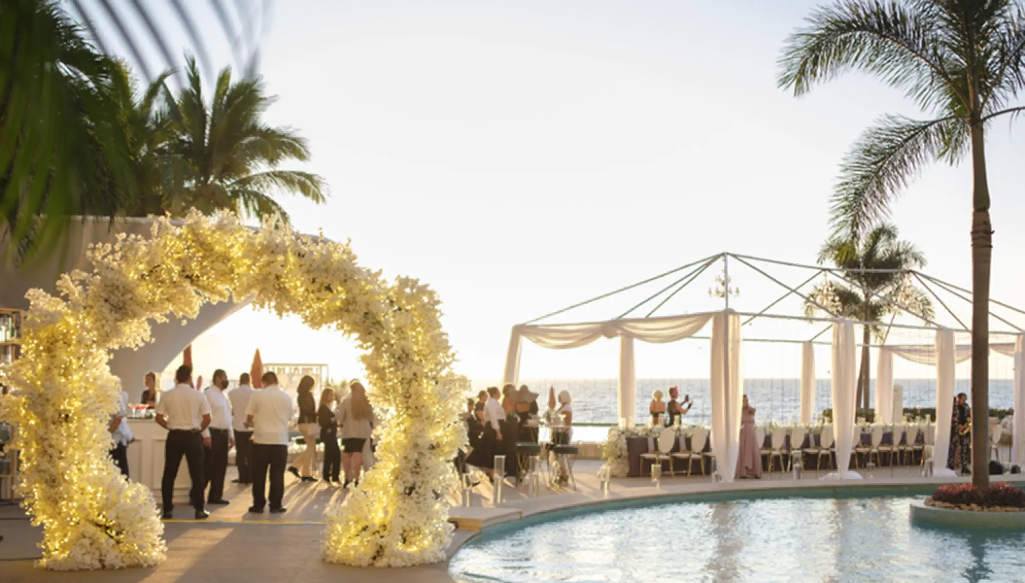 Outdoor wedding reception by the pool at Hilton Vallarta Riviera overlooking the ocean, Puerto Vallarta