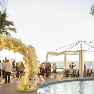Outdoor wedding reception by the pool at Hilton Vallarta Riviera overlooking the ocean, Puerto Vallarta