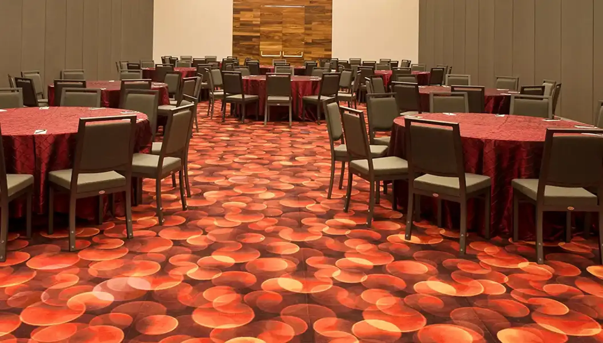 Indoor wedding reception with round tables and red linens at Hilton Vallarta Riviera, Puerto Vallarta