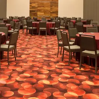 Indoor wedding reception with round tables and red linens at Hilton Vallarta Riviera, Puerto Vallarta