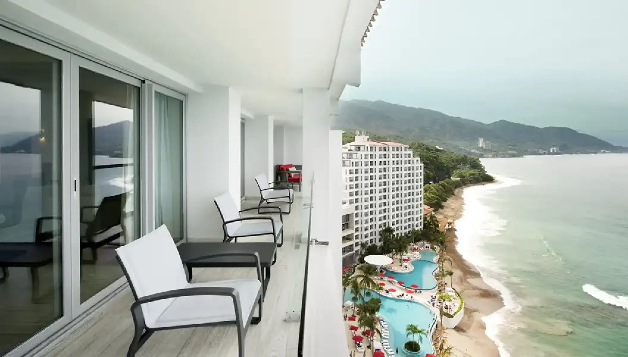 Presidential suite balcony with views of the beach and pool at Hilton Vallarta Riviera, Puerto Vallarta