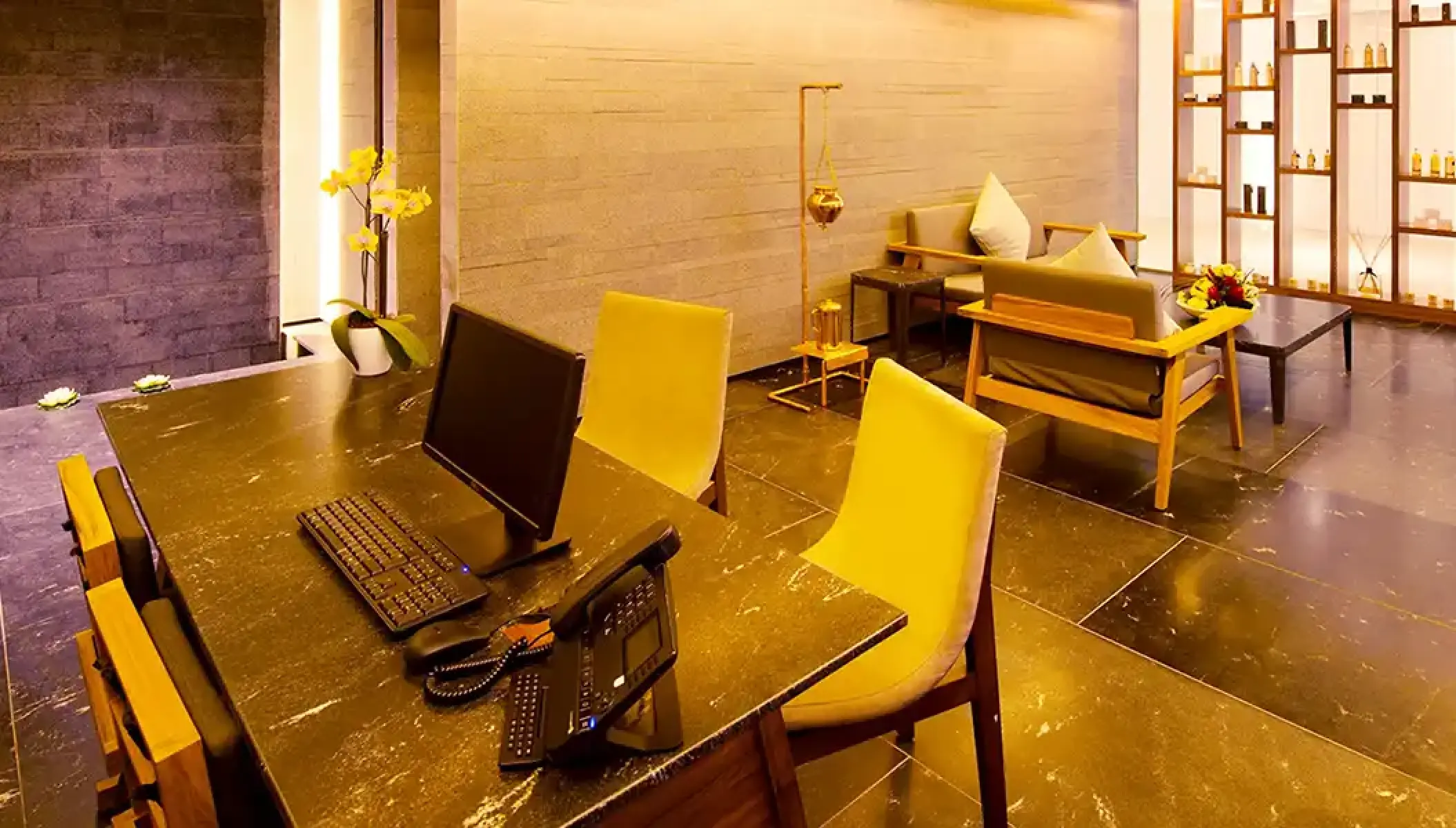 Spa reception desk and lounge area with warm lighting at Hilton Vallarta Riviera, Puerto Vallarta