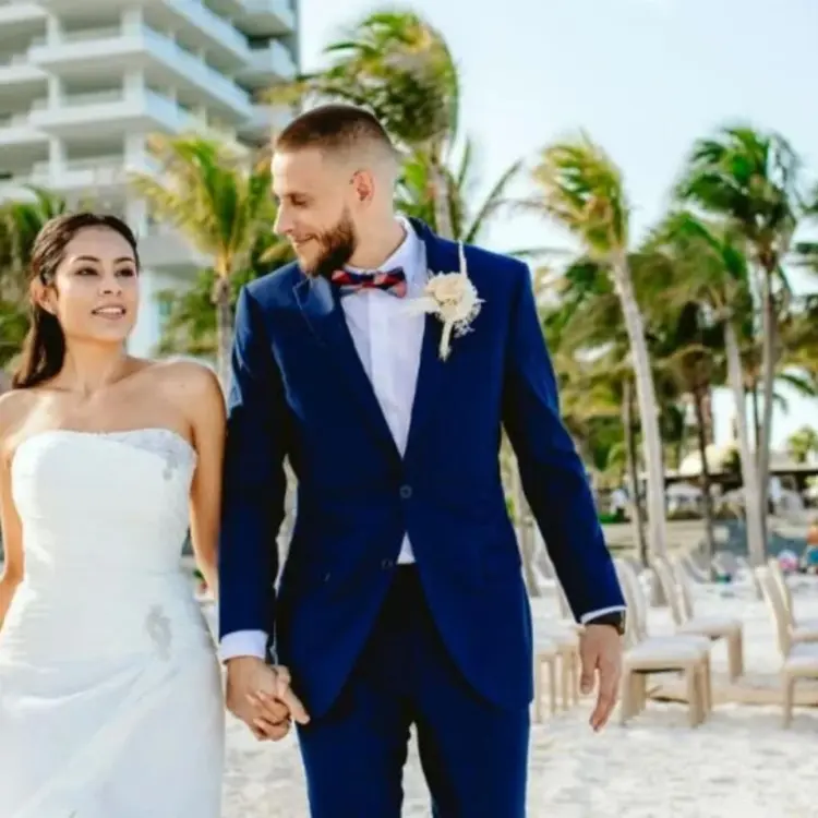 Bride and groom walking on the beach at Hotel Mousai, Cancun