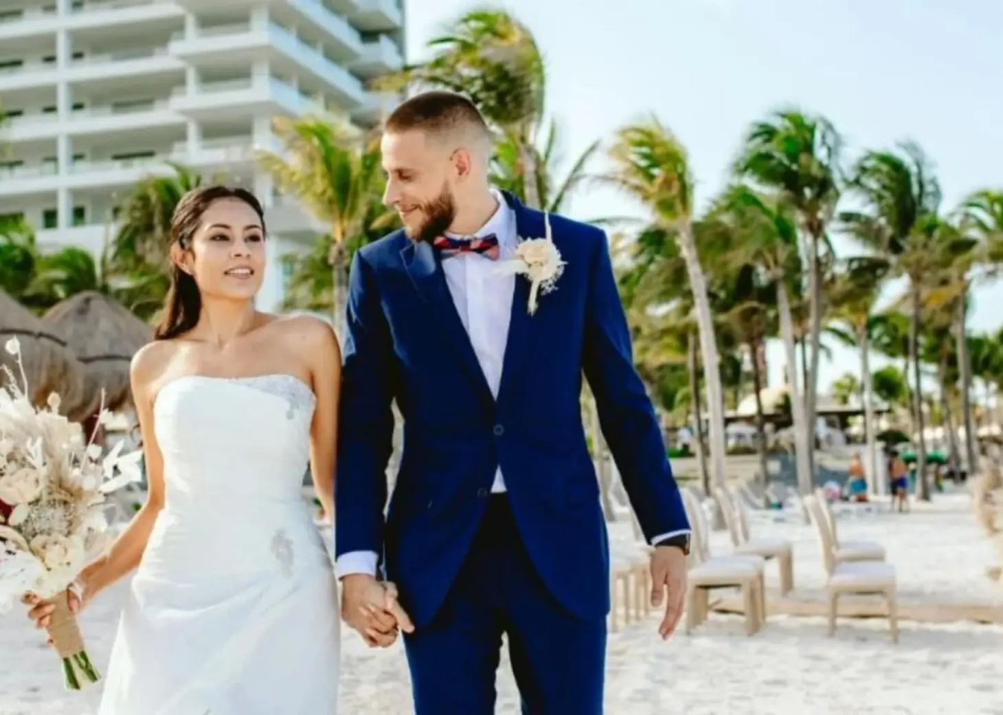 Bride and groom walking on the beach at Hotel Mousai, Cancun