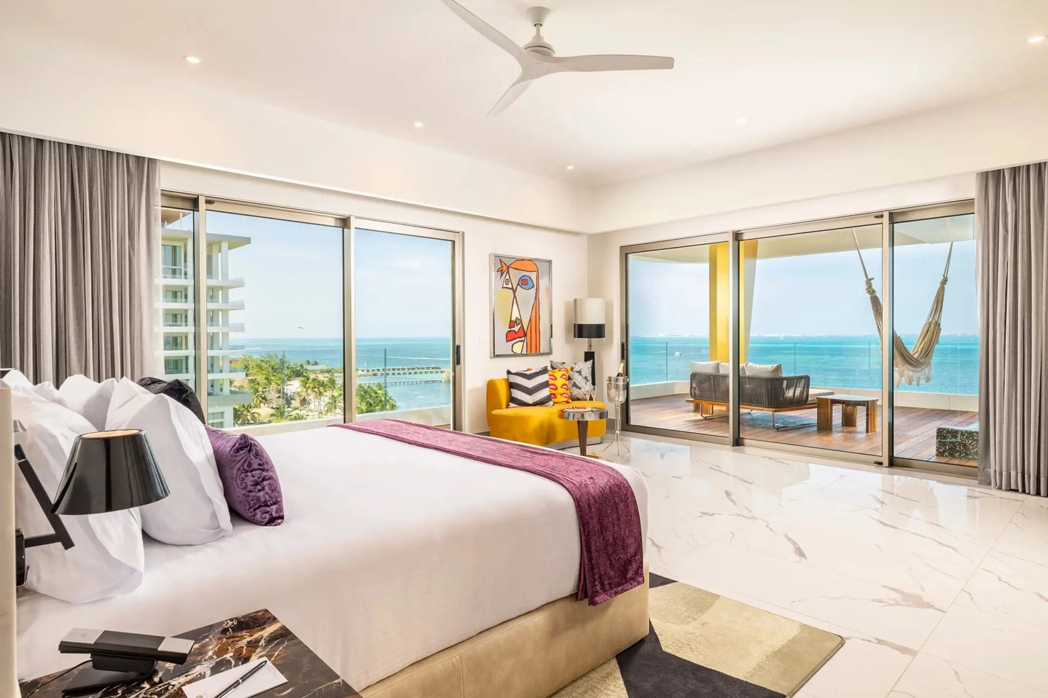 Corner suite at Hotel Mousai Cancun with floor-to-ceiling windows and ocean views, Cancun