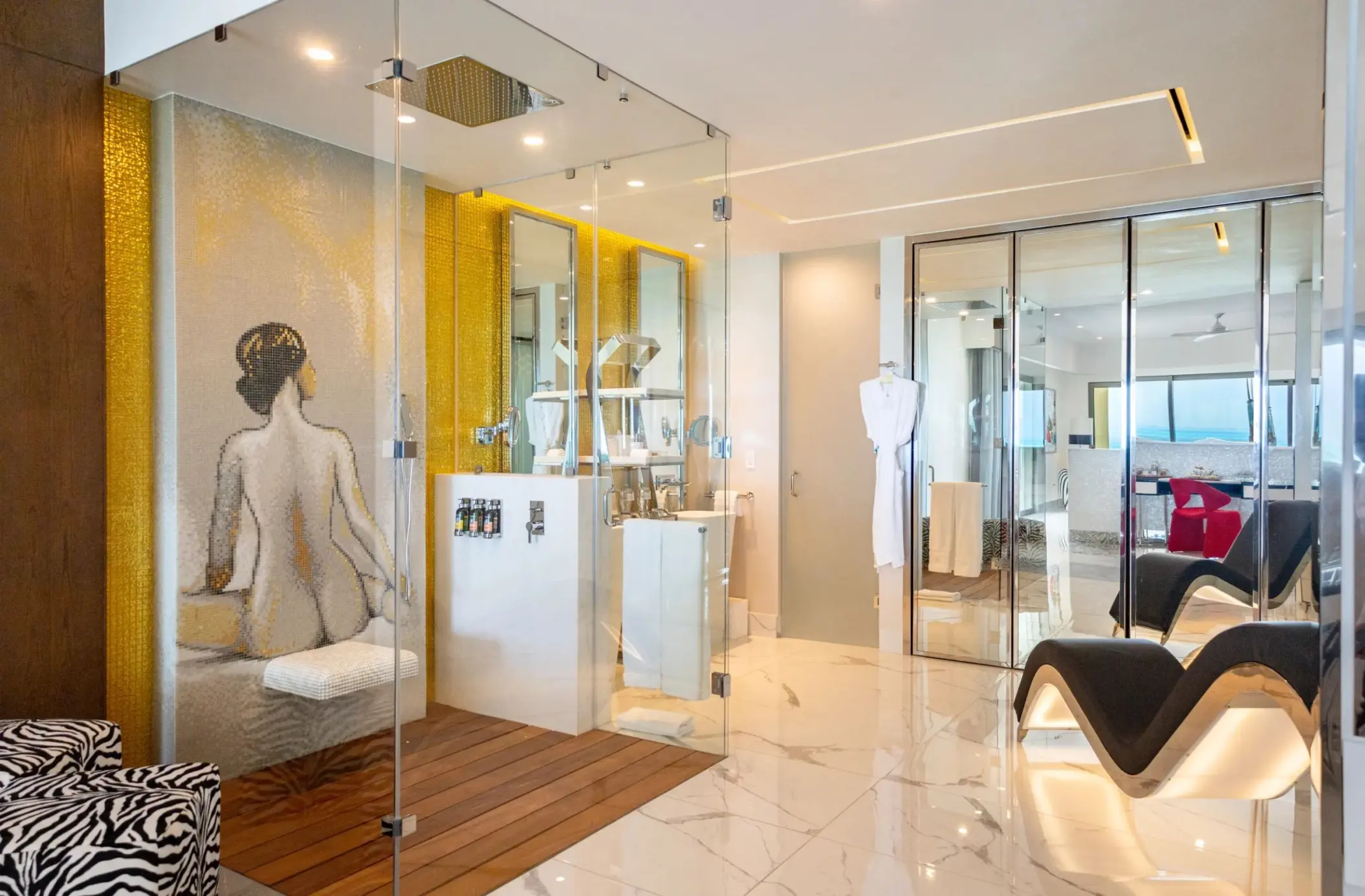 Modern suite bathroom with glass shower and mosaic tile art at Hotel Mousai Cancun