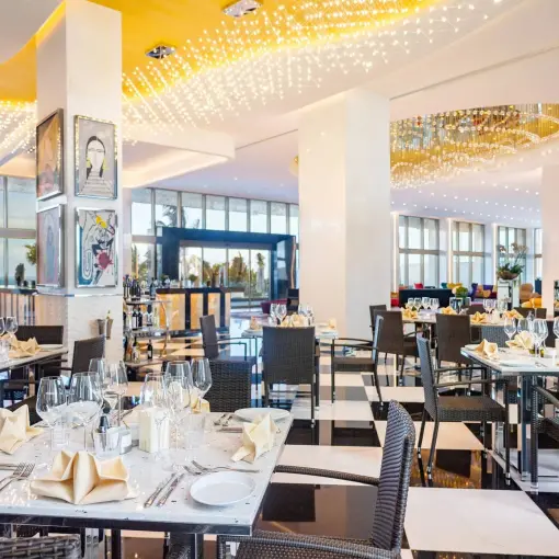 Modern gourmet restaurant interior with black and white checkered floors at Hotel Mousai Cancun