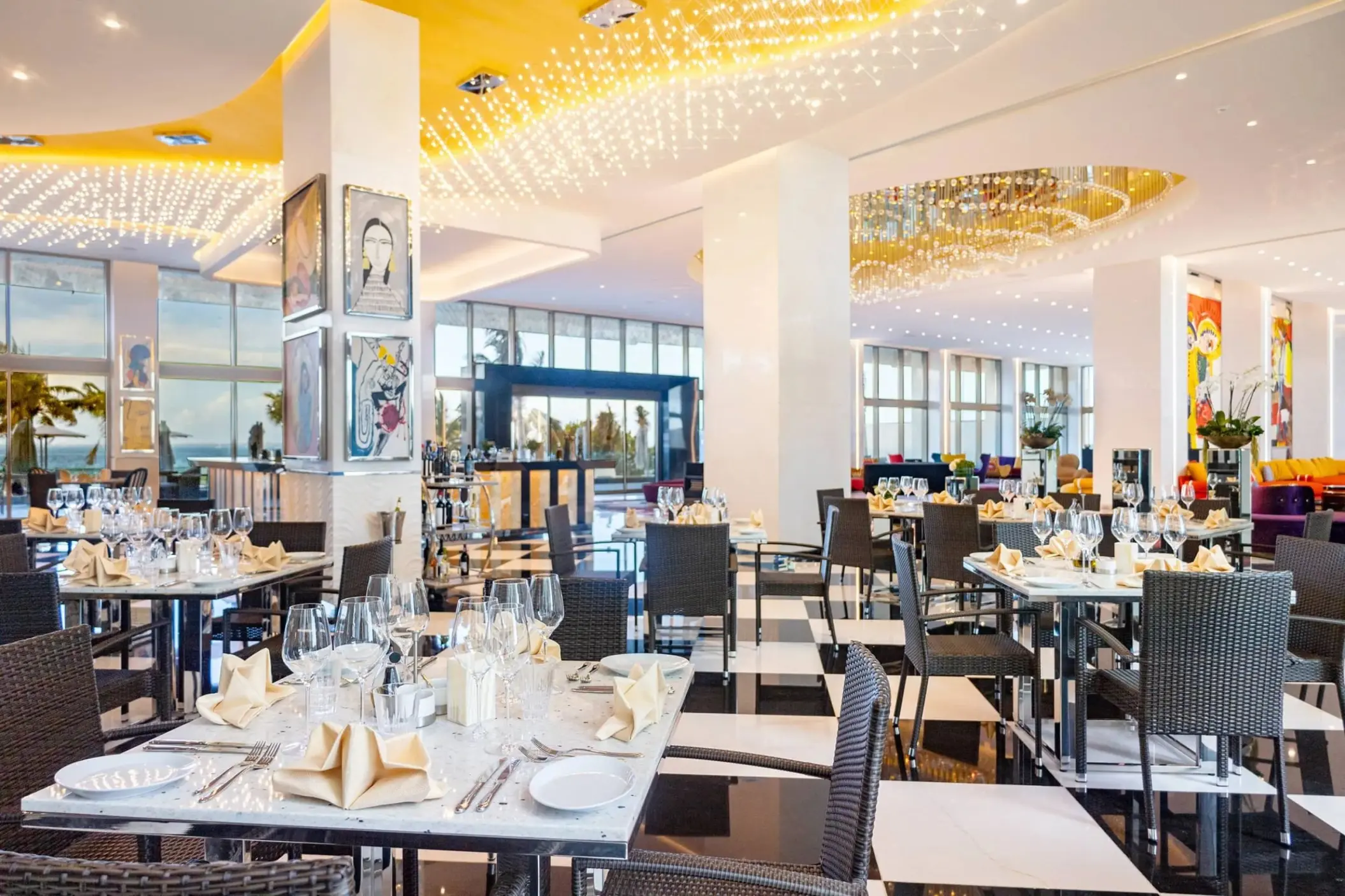 Modern gourmet restaurant interior with black and white checkered floors at Hotel Mousai Cancun