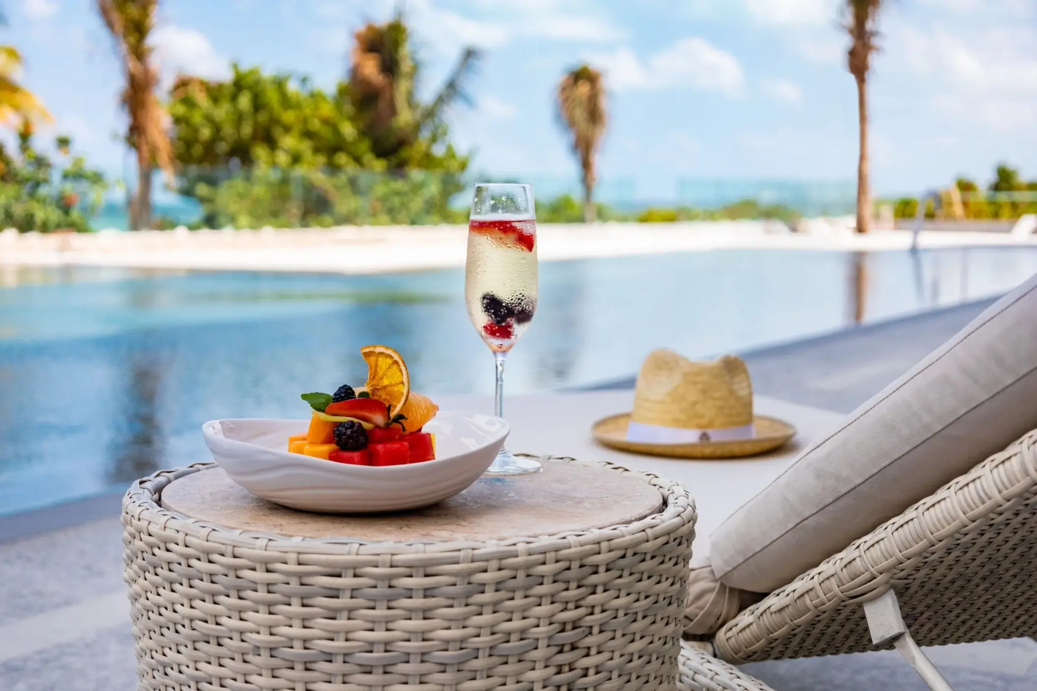 Fruit plate and berry cocktail poolside at Hotel Mousai Cancun, Cancun