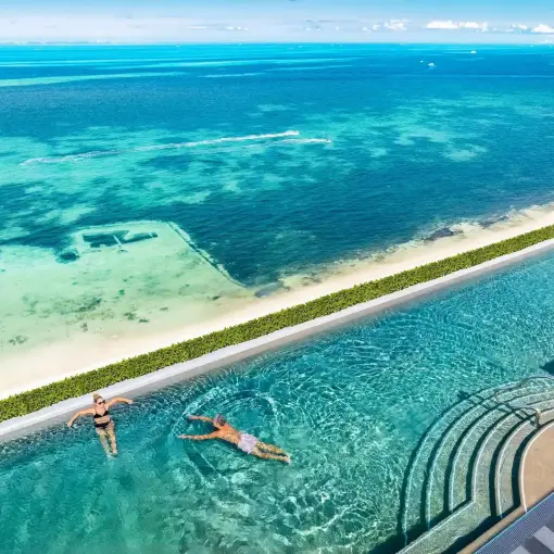 Rooftop infinity pool overlooking the turquoise Caribbean Sea at Hotel Mousai Cancun