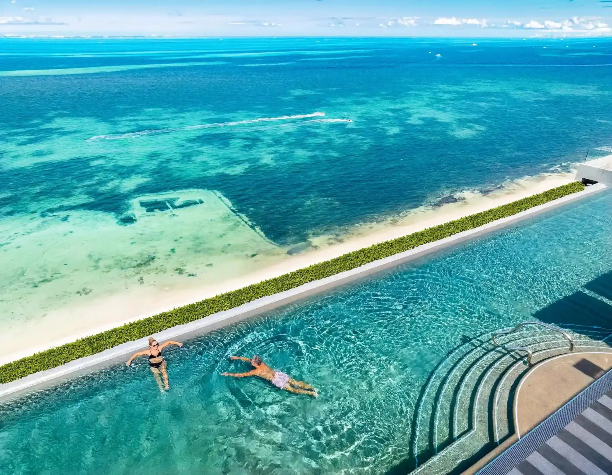 Rooftop infinity pool overlooking the turquoise Caribbean Sea at Hotel Mousai Cancun