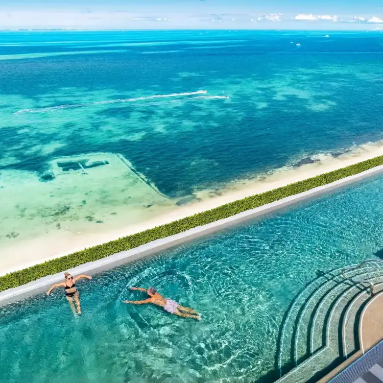 Rooftop infinity pool overlooking the turquoise Caribbean Sea at Hotel Mousai Cancun