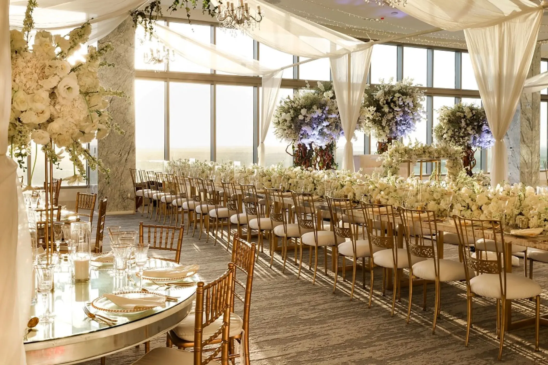 Indoor wedding reception venue with floral arrangements and long tables at Hotel Mousai Cancun