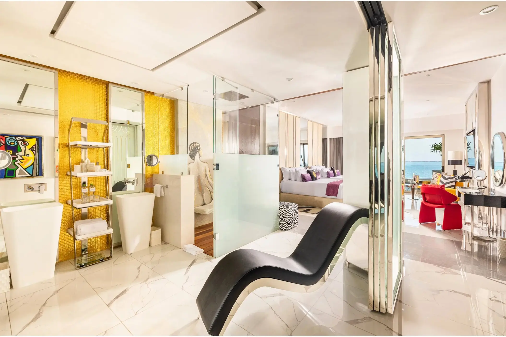 Modern suite with white marble floors, glass shower, and ocean view at Hotel Mousai Cancun