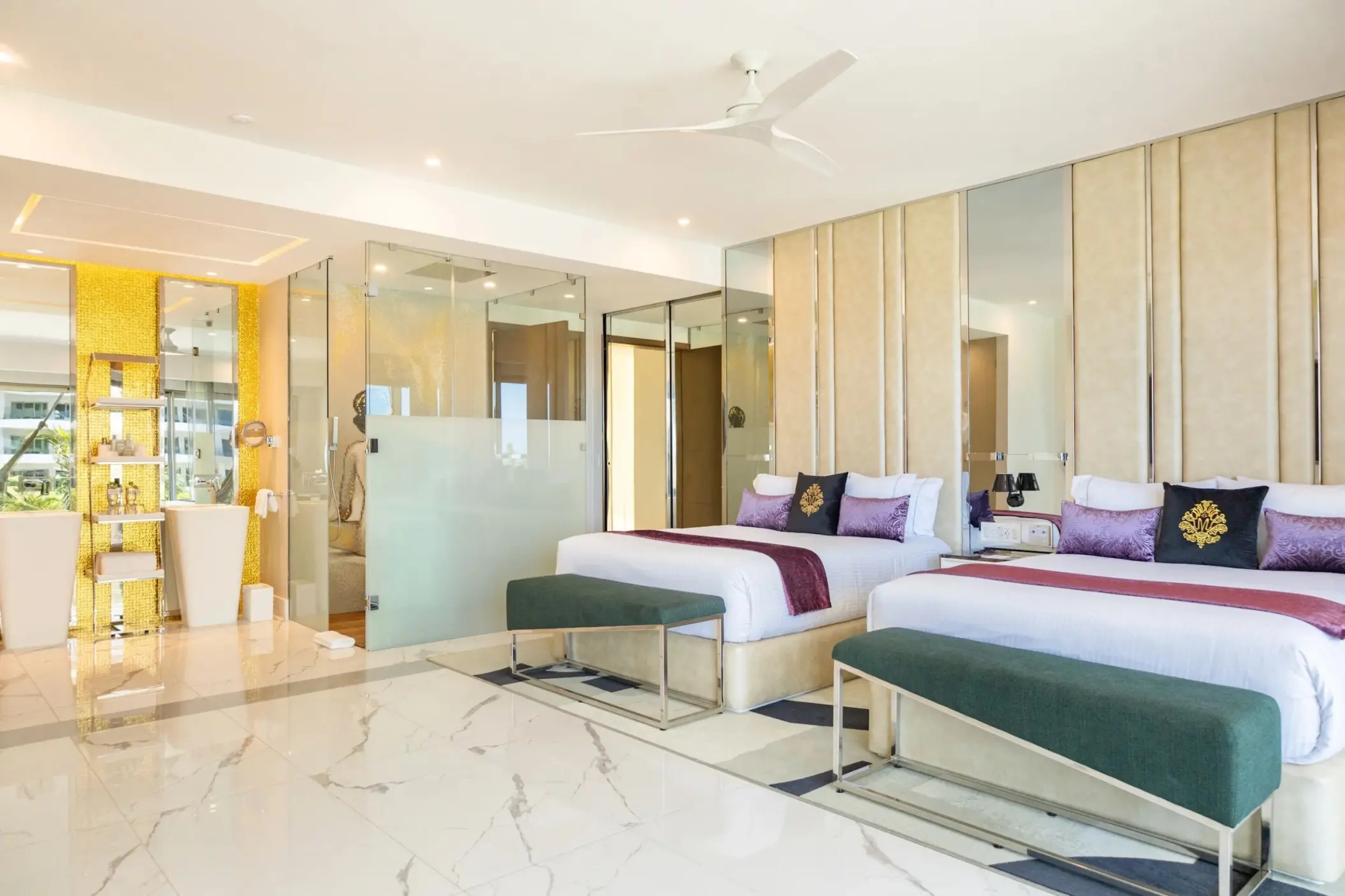 Modern two-bedroom master suite with marble floors and purple accents at Hotel Mousai Cancun