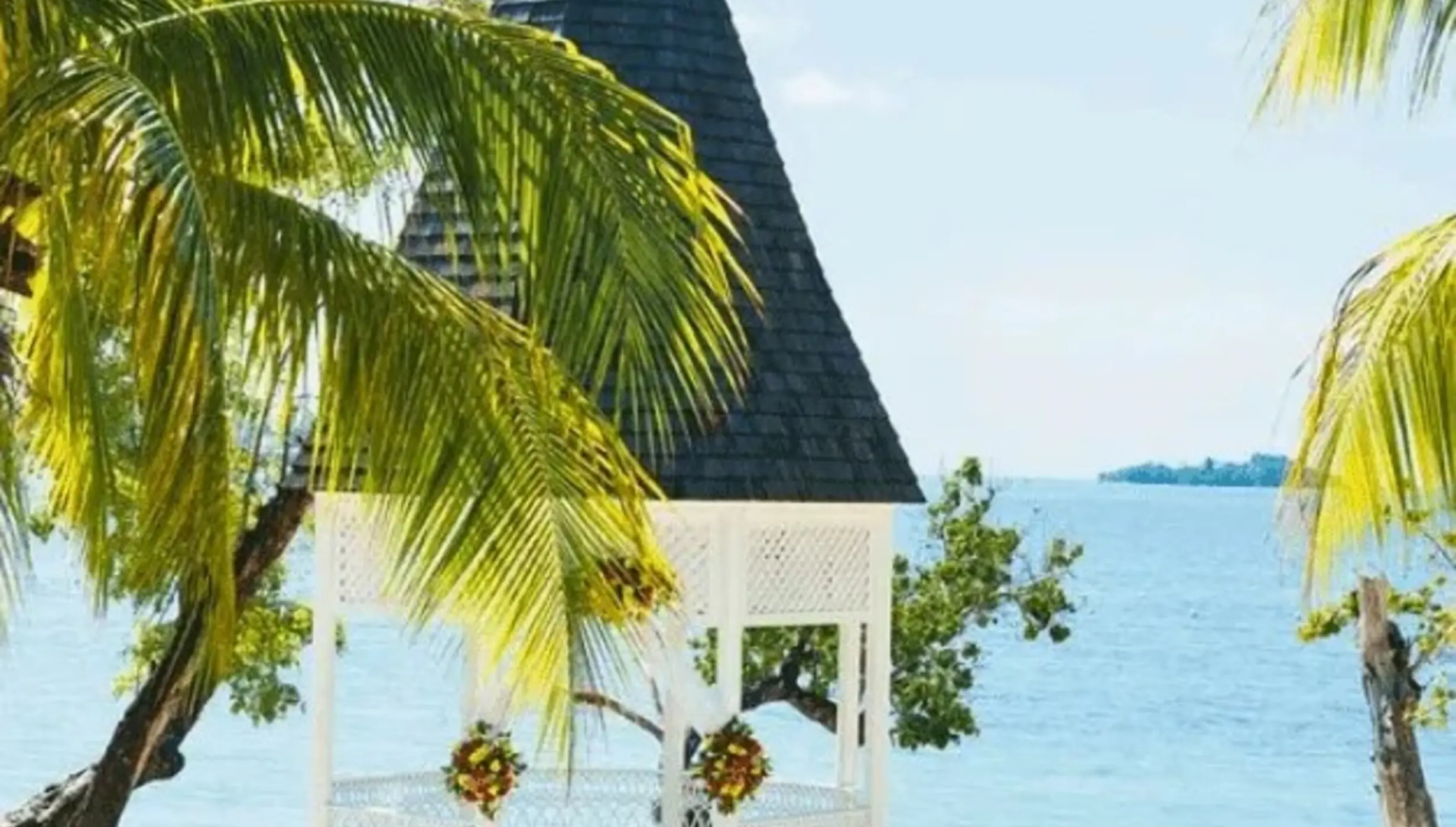 Beachfront wedding ceremony gazebo with white chairs at Riu Negril, Negril