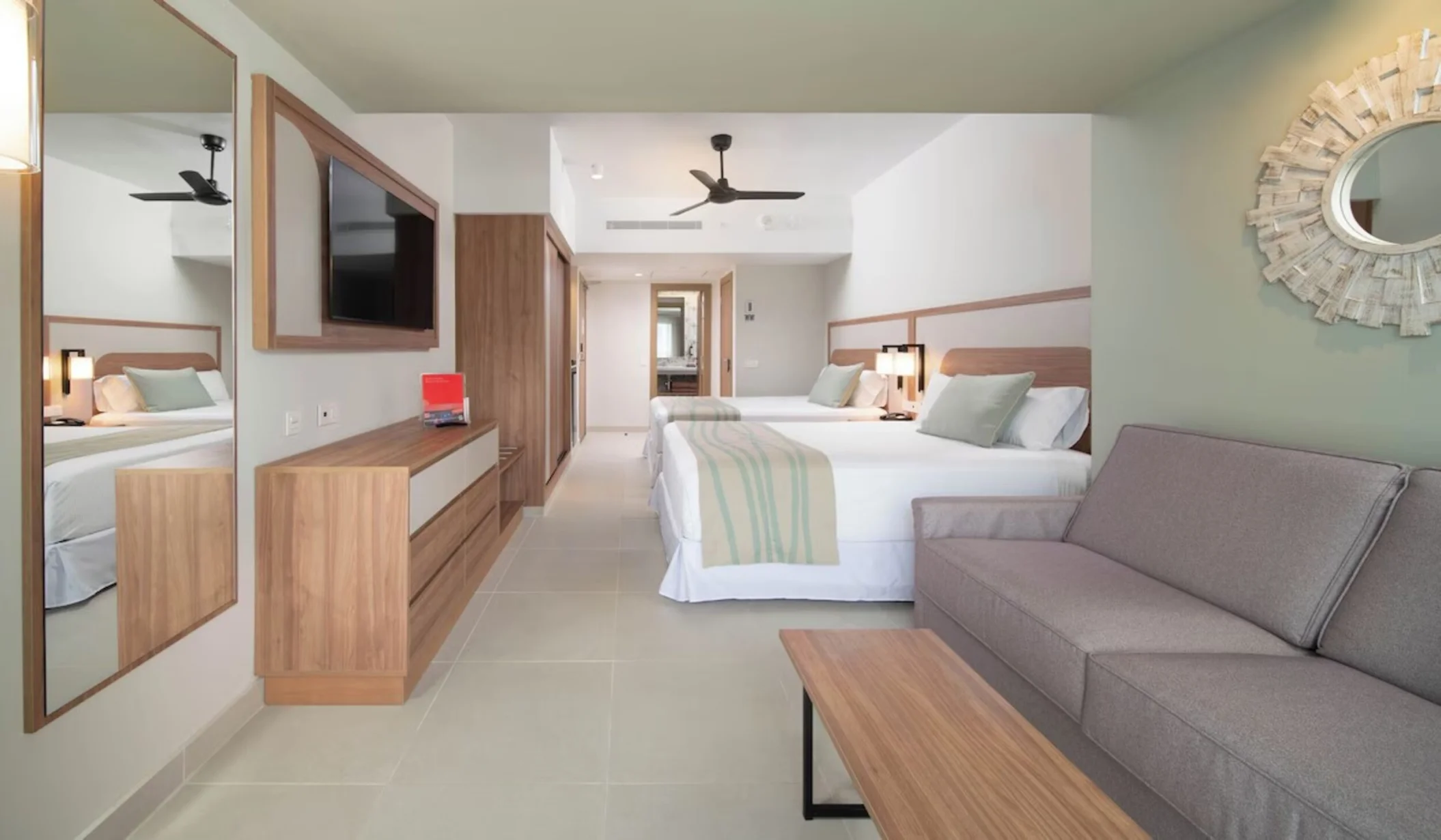 Furnished room with 2 beds and sofa at Hotel Riu Negril