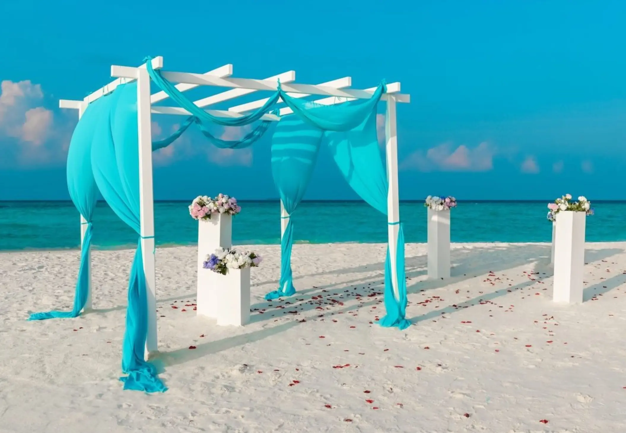 White pergola beach ceremony venue with turquoise fabric at Riu Palace Aquarelle, Montego Bay