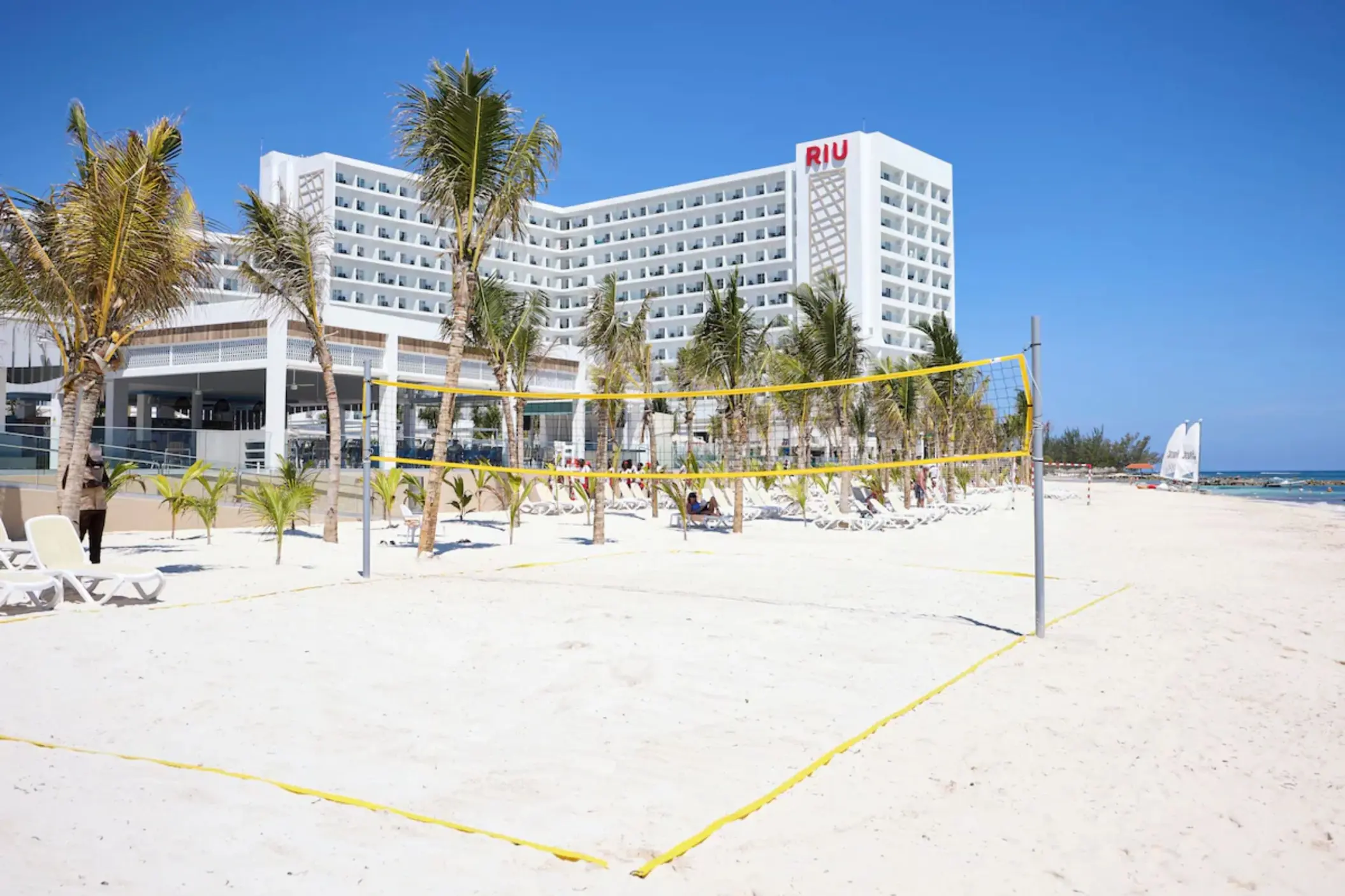 Beach volleyball court at Riu Palace Aquarelle overlooking the white sand and resort exterior, Montego Bay