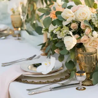 Wedding reception table setup with white roses and eucalyptus at Riu Palace Aquarelle, Montego Bay