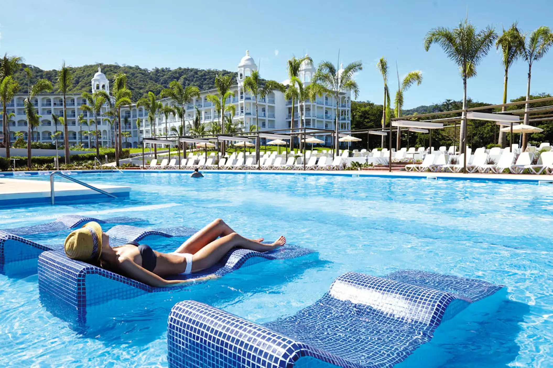 woman lounging in the pool at Hotel Riu Palace Costa Rica