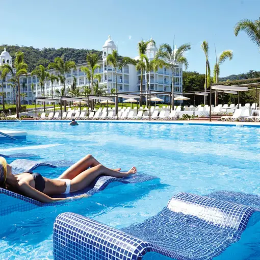 woman lounging in the pool at Hotel Riu Palace Costa Rica